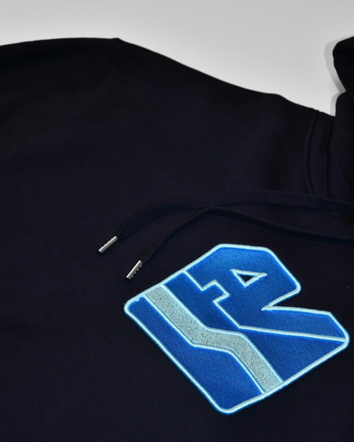 Embroidered logo on a navy hoodie