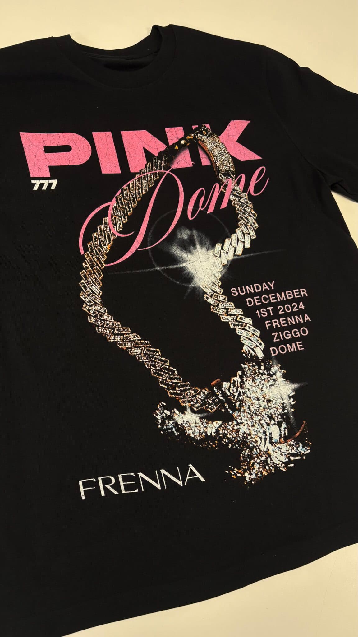 Black tee with a pink and gold print