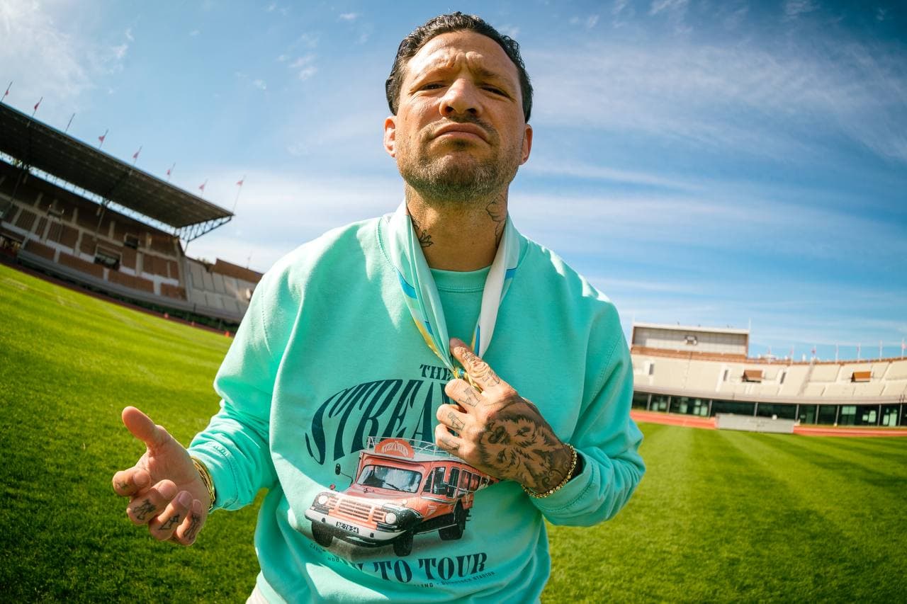 A customer wearing a mint DROPLET-made hoodie in a stadium